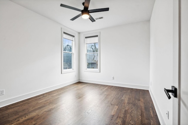 spare room featuring dark hardwood / wood-style flooring and ceiling fan