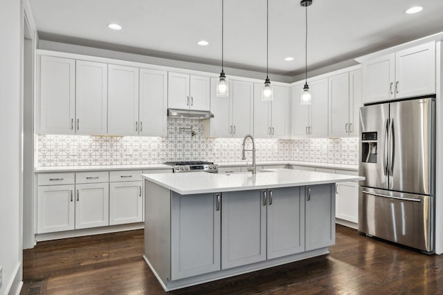 kitchen with white cabinetry, dark hardwood / wood-style flooring, stainless steel appliances, and decorative light fixtures