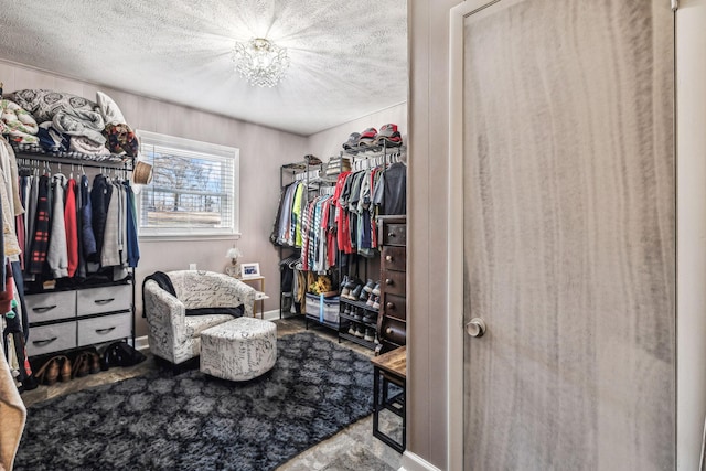 walk in closet featuring a chandelier