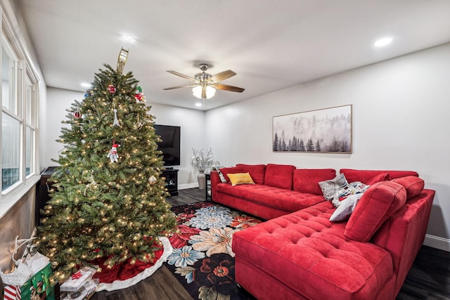 living room featuring ceiling fan and dark hardwood / wood-style floors