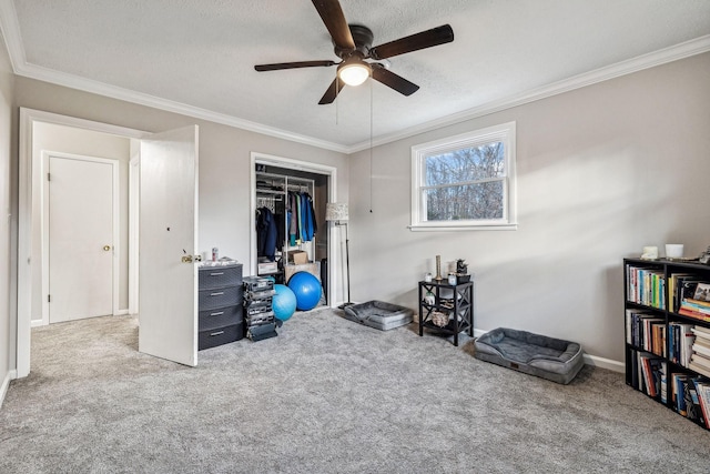 interior space featuring ceiling fan, crown molding, carpet floors, and a textured ceiling