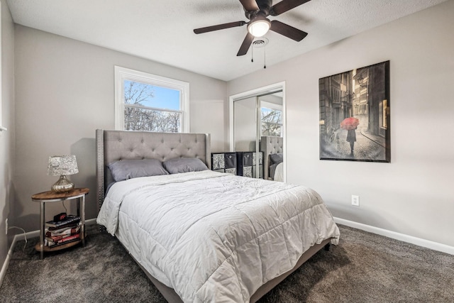 carpeted bedroom featuring a textured ceiling, a closet, and ceiling fan