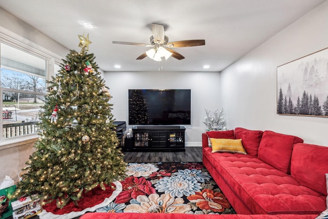 living room with wood-type flooring and ceiling fan