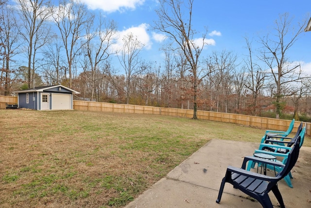 129 Dylark Dr, Waverly, TN 37185 - fenced backyard featuring a patio area, an outdoor structure, a garage, and view of scattered trees