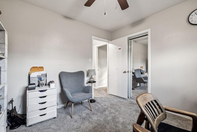 sitting room with ceiling fan and carpet