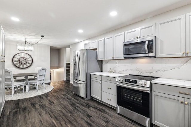 129 Dylark Dr, Waverly, TN 37185 - kitchen with stainless steel appliances, recessed lighting, gray cabinetry, dark wood-style floors, and decorative backsplash
