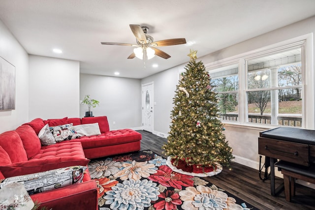 living room featuring ceiling fan and dark wood-type flooring