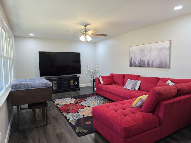 living room with ceiling fan and dark wood-type flooring