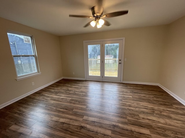 empty room with ceiling fan and dark hardwood / wood-style flooring