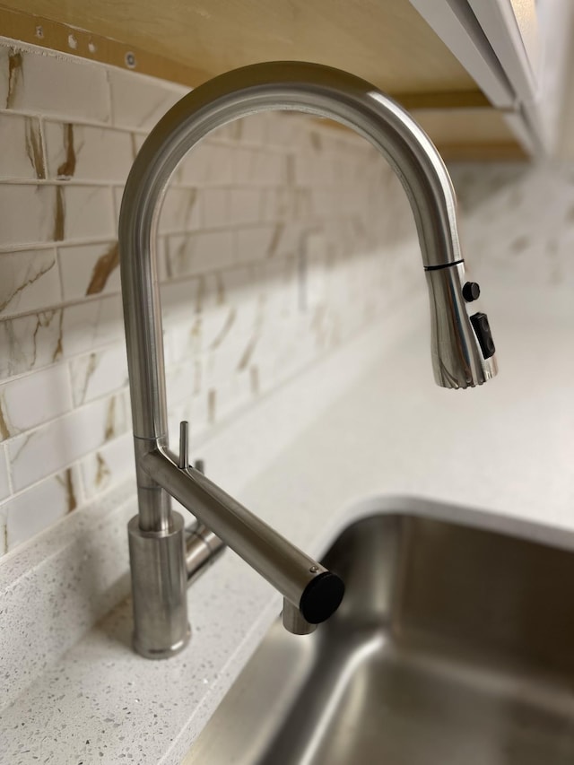 room details with light stone counters and sink