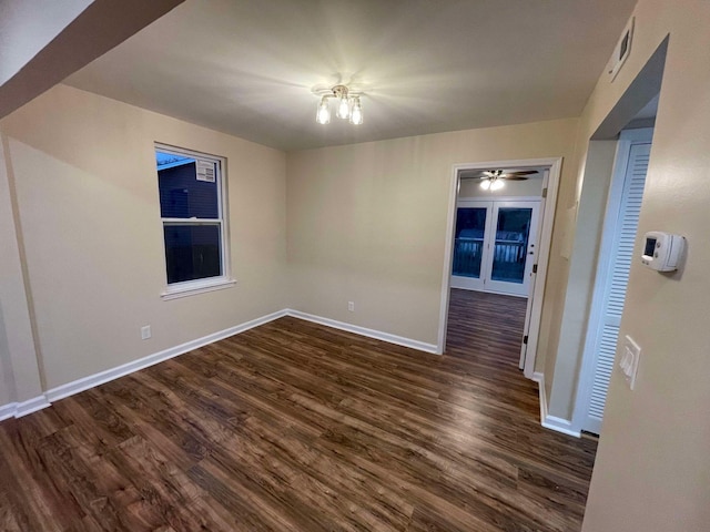 unfurnished room featuring dark hardwood / wood-style floors and a notable chandelier