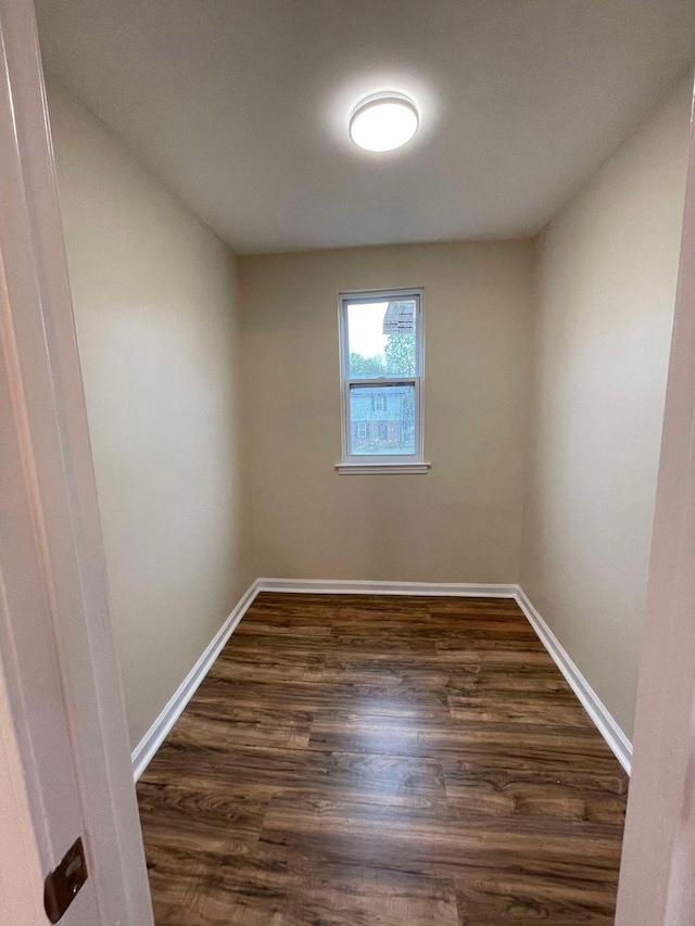 unfurnished room with dark hardwood / wood-style floors