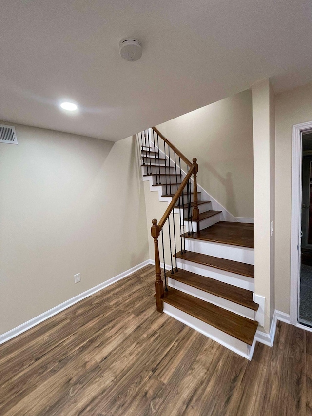 stairs with wood-type flooring