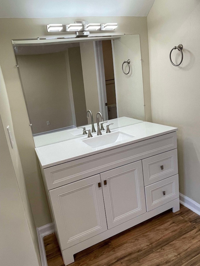 bathroom with vanity and hardwood / wood-style flooring