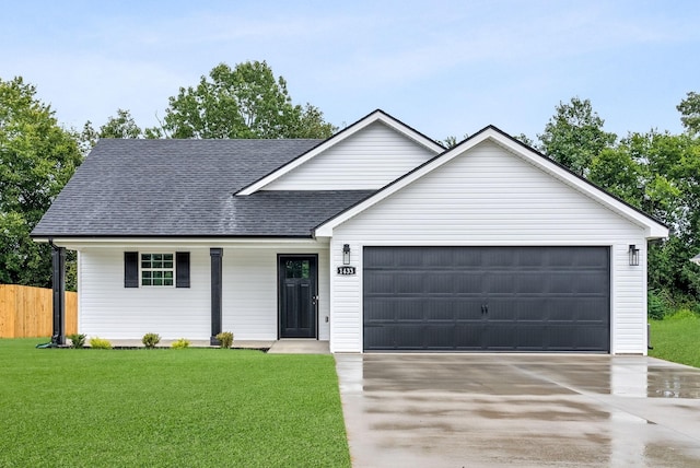 ranch-style house featuring a front yard and a garage