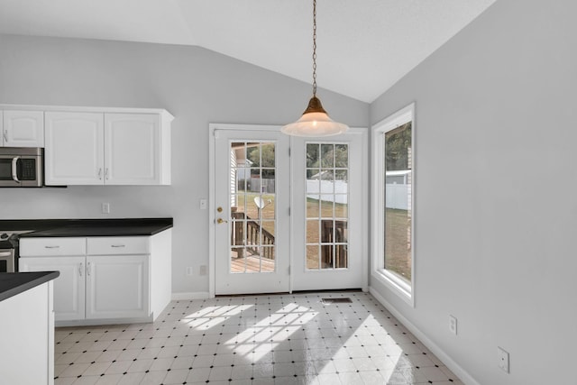 unfurnished dining area with a healthy amount of sunlight and lofted ceiling