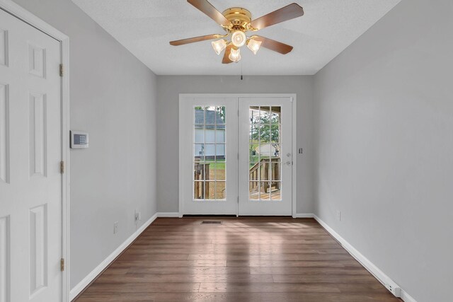 entryway featuring ceiling fan, dark hardwood / wood-style flooring, and a textured ceiling