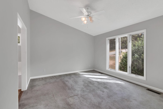 empty room with ceiling fan and carpet