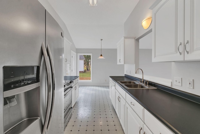 kitchen featuring hanging light fixtures, sink, white cabinets, and stainless steel appliances