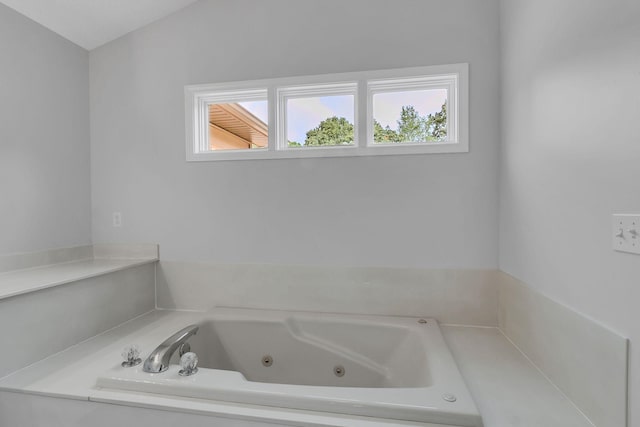 bathroom featuring tiled tub