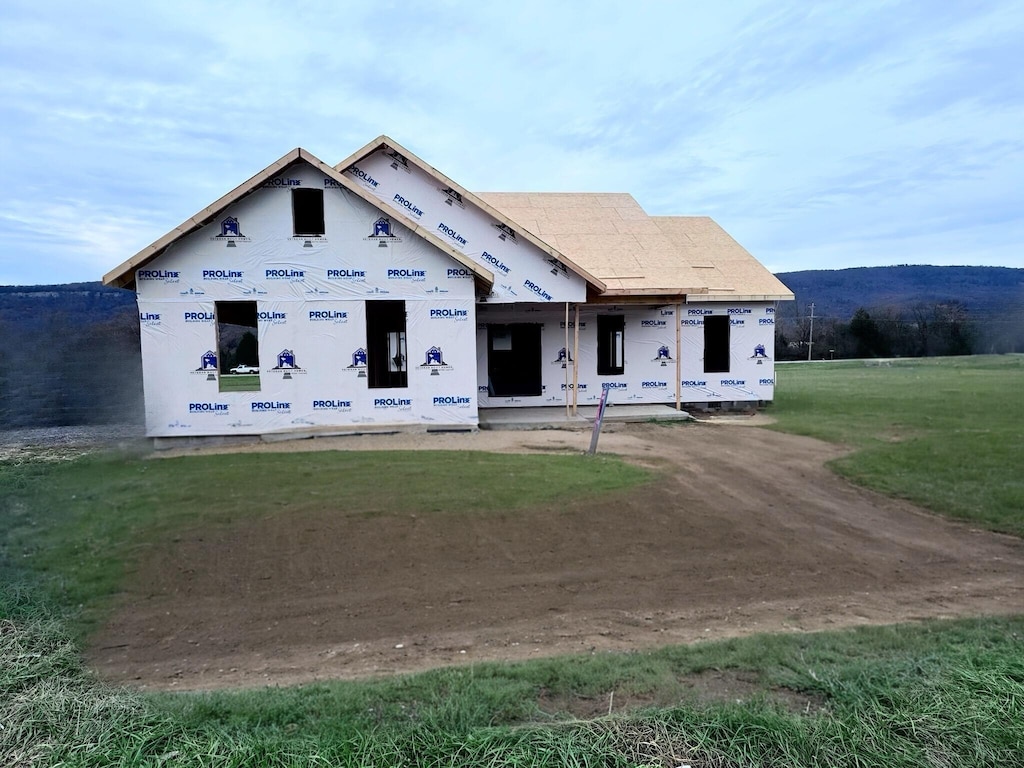 property in mid-construction featuring a front yard