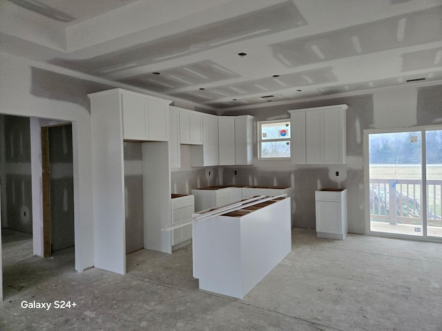 kitchen with white cabinetry and a center island