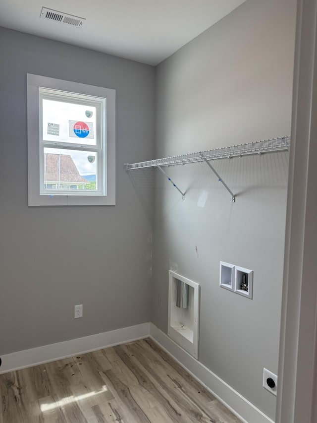 10 Shagbark Cv, Dunlap, TN 37327 - washroom with electric dryer hookup, wood finished floors, washer hookup, and baseboards