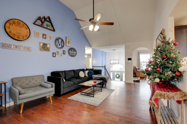 living room with hardwood / wood-style floors, ceiling fan, and high vaulted ceiling