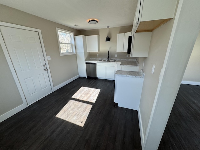 interior space with dark hardwood / wood-style flooring, white cabinets, decorative light fixtures, and dishwasher