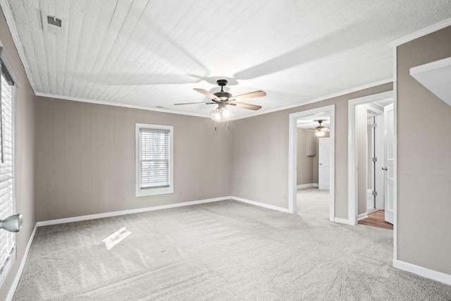 unfurnished room with ceiling fan, light colored carpet, and ornamental molding