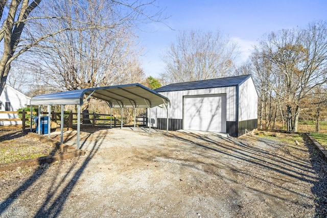 view of outdoor structure with a carport and a garage