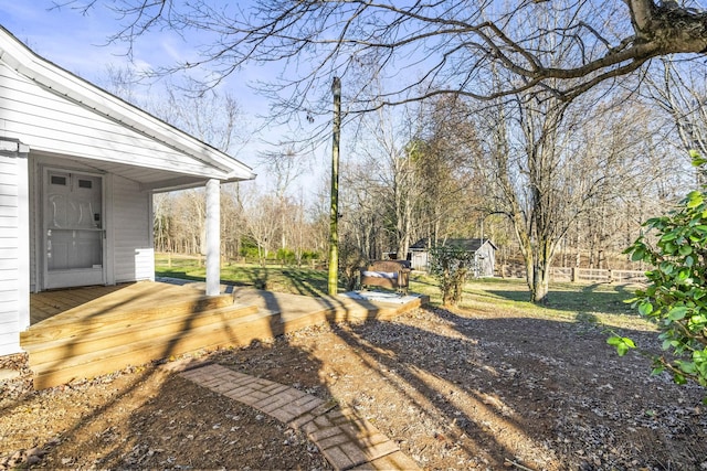 view of yard with a shed and a wooden deck