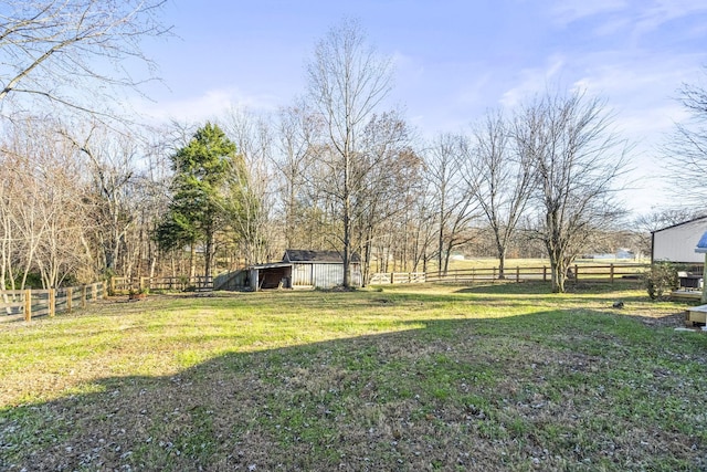 view of yard with a rural view and an outdoor structure