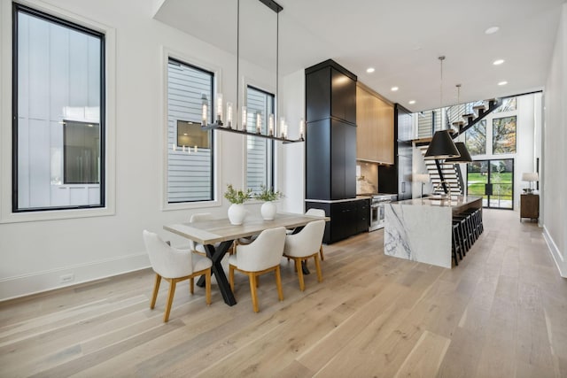 dining space featuring light hardwood / wood-style flooring and sink