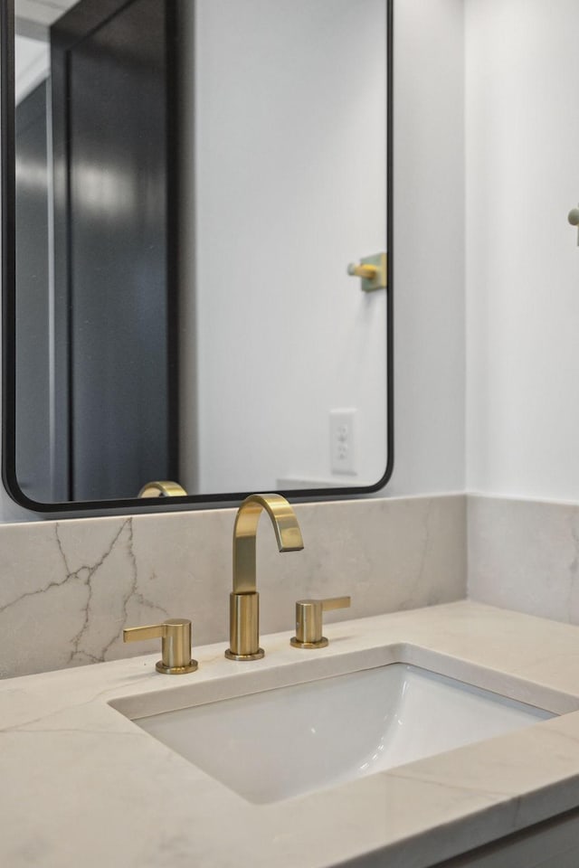 bathroom with vanity and tasteful backsplash