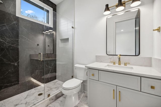 bathroom with vanity, toilet, and a shower with door