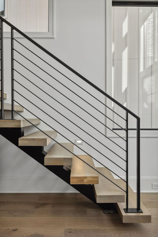 stairs featuring hardwood / wood-style flooring