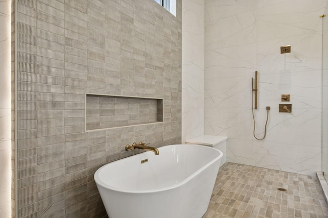 bathroom featuring tile walls and plus walk in shower