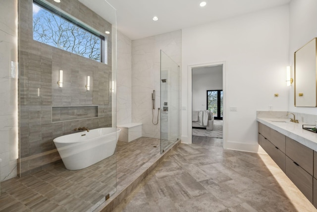 bathroom with vanity, tile walls, and independent shower and bath