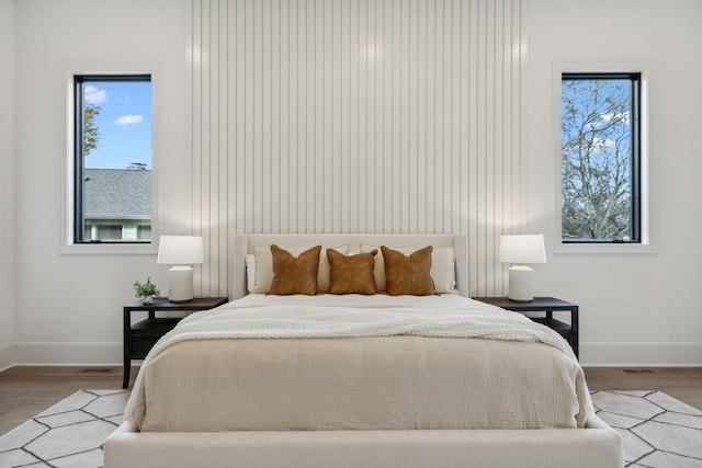 bedroom with hardwood / wood-style flooring