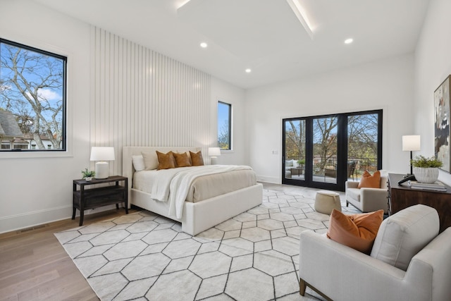 bedroom featuring light hardwood / wood-style floors and access to outside