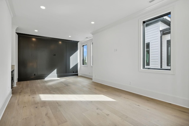 unfurnished room with crown molding and light hardwood / wood-style flooring