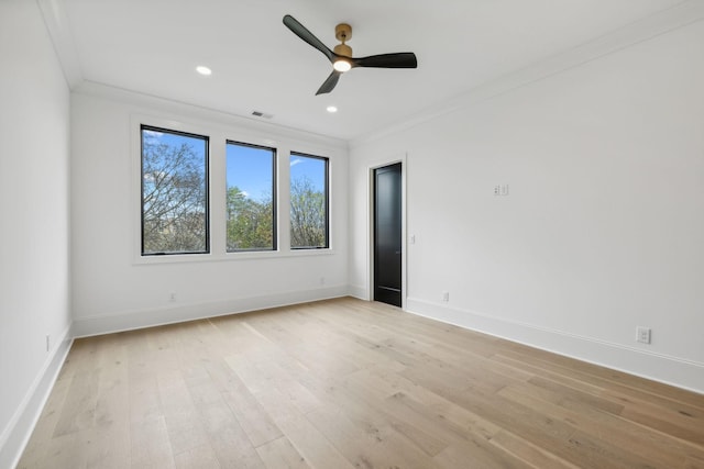 empty room featuring crown molding, ceiling fan, and light hardwood / wood-style floors