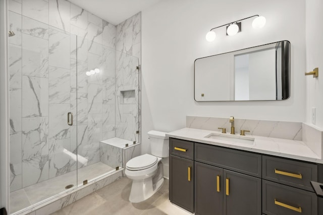 bathroom featuring vanity, an enclosed shower, and toilet