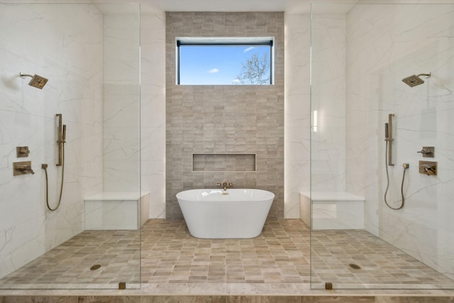 bathroom with tile walls and independent shower and bath