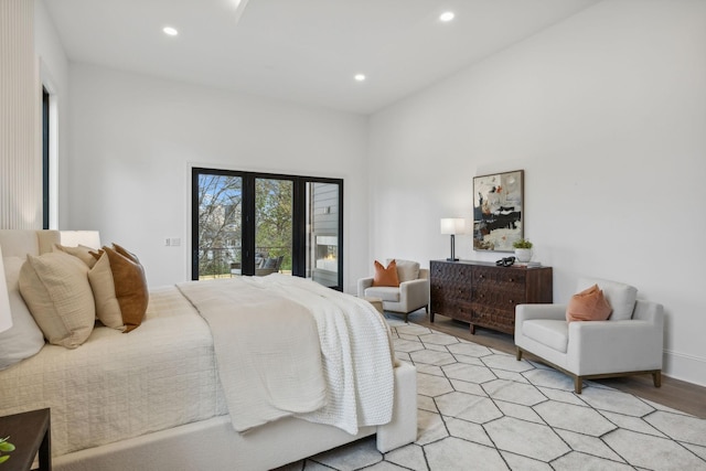 bedroom with access to outside and light hardwood / wood-style flooring