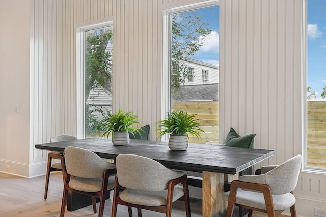 dining room with a wealth of natural light and hardwood / wood-style floors