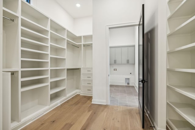 spacious closet with light hardwood / wood-style flooring