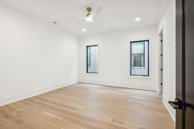 spare room featuring ceiling fan, crown molding, and light wood-type flooring