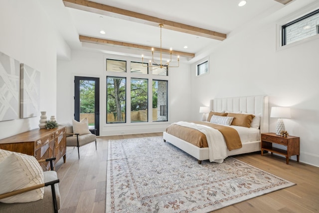 bedroom featuring wood-type flooring and a notable chandelier